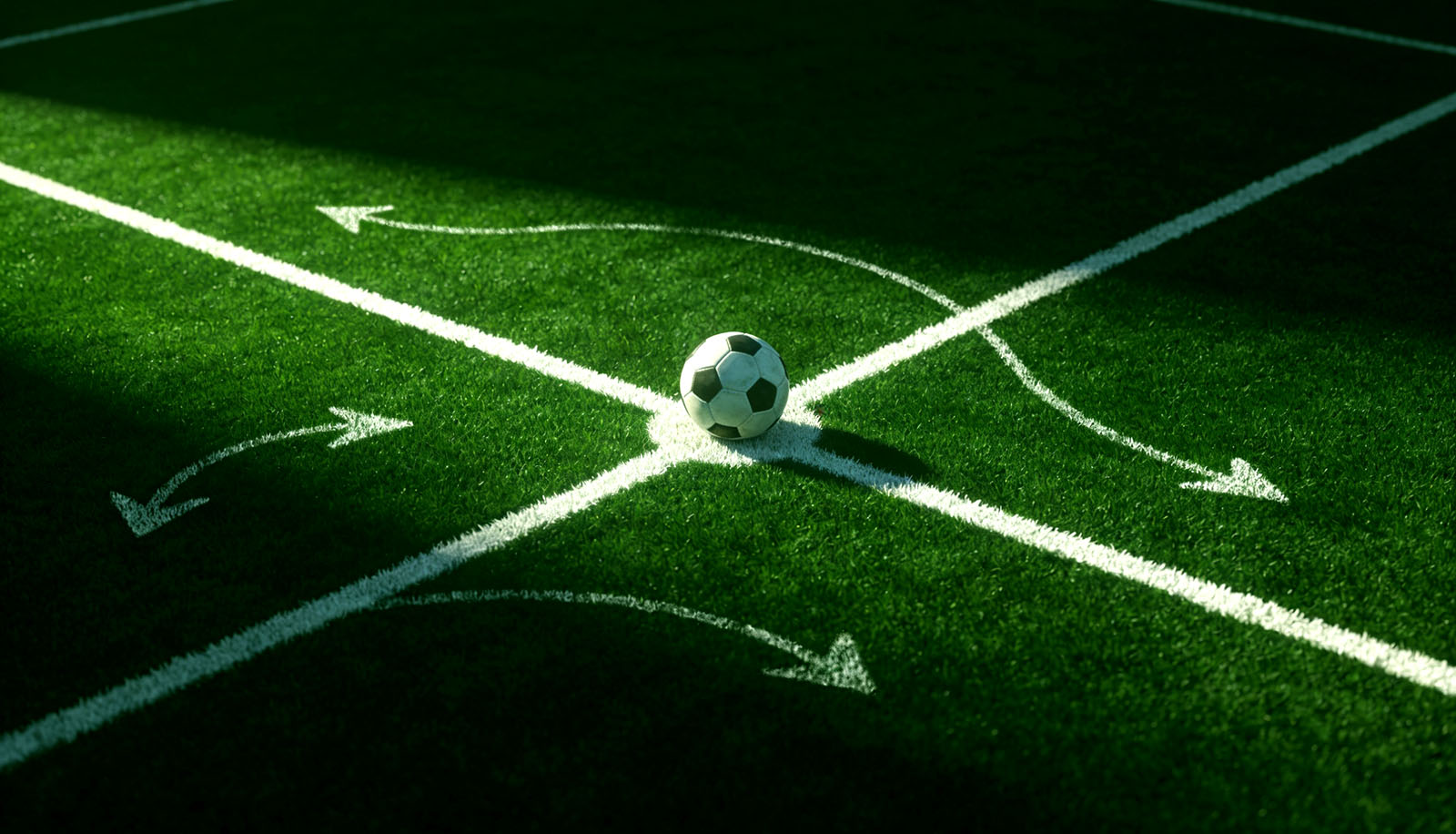 Chalk tactical arrows drawn around a football on the centre spot